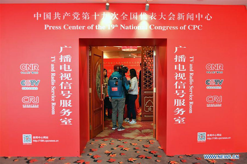 Journalists consult in the TV and radio service room of the Press Center of the 19th National Congress of the Communist Party of China in Beijing, capital of China, Oct. 11, 2017. The press center based in the Beijing Media Center Hotel began operations on Wednesday. (Xinhua/Li Xin)