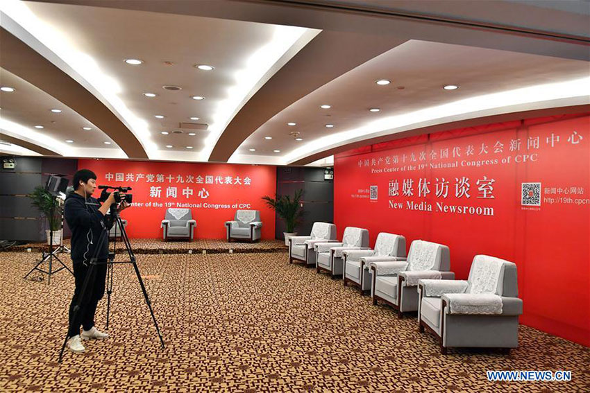 A journalist takes video in the new media newsroom of the Press Center of the 19th National Congress of the Communist Party of China in Beijing, capital of China, Oct. 11, 2017. The press center based in the Beijing Media Center Hotel began operations on Wednesday. (Xinhua/Li Xin)