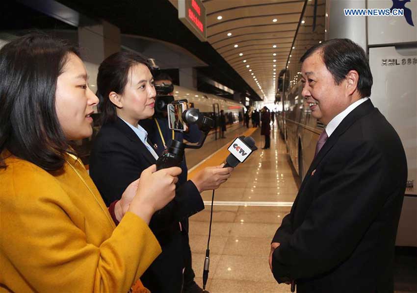 Wu Xie'en (R), a delegate of Jiangsu Province to the 19th National Congress of the Communist Party of China (CPC), receives an interview upon his arrival in Beijing, capital of China, Oct. 16, 2017. Delegates of Jiangsu Province to the 19th CPC National Congress arrived in Beijing on Monday. The congress will start on Oct. 18 in Beijing. (Xinhua/Jin Liwang)