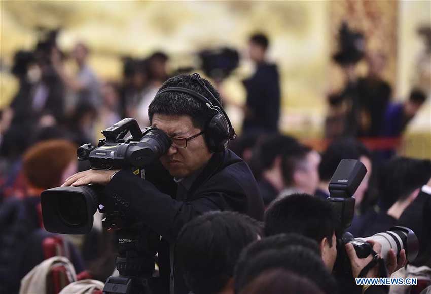 Photo taken on Oct. 17, 2017 shows a cameraman working at a press conference held by Tuo Zhen, spokesperson for the 19th National Congress of the Communist Party of China, at the Great Hall of the People in Beijing, capital of China. (Xinhua/Liu Jinhai) 