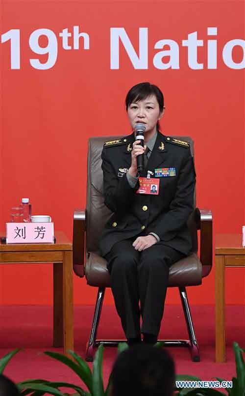 Liu Fang, a staff officer of the Office for International Military Cooperation of the Central Military Commission, answers questions during a group interview on "solid strides on the path of building a powerful military with Chinese characteristics", held by the press center of the 19th National Congress of the Communist Party of China (CPC) in Beijing, capital of China, Oct. 22, 2017. (Xinhua/Chen Yehua)