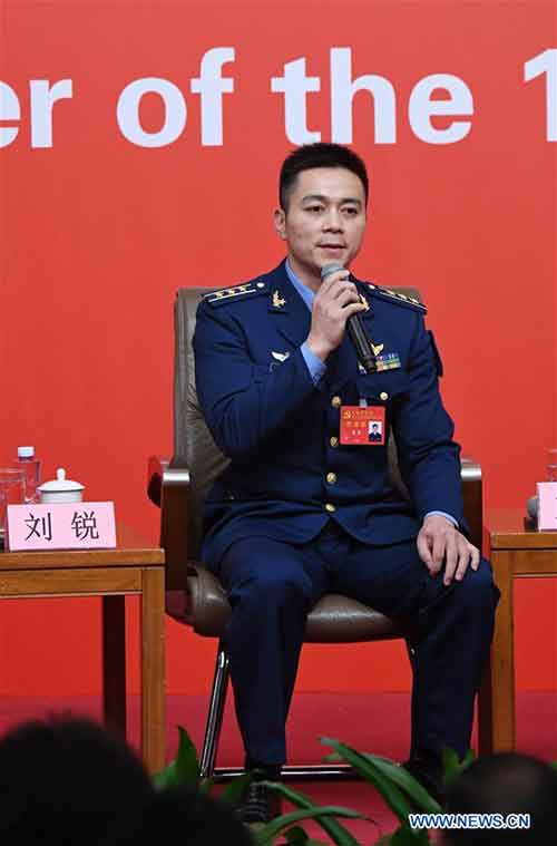 Liu Rui, an aviation regiment commander of the People's Liberation Army Air Force, answers questions during a group interview on "solid strides on the path of building a powerful military with Chinese characteristics", held by the press center of the 19th National Congress of the Communist Party of China (CPC) in Beijing, capital of China, Oct. 22, 2017. (Xinhua/Chen Yehua)