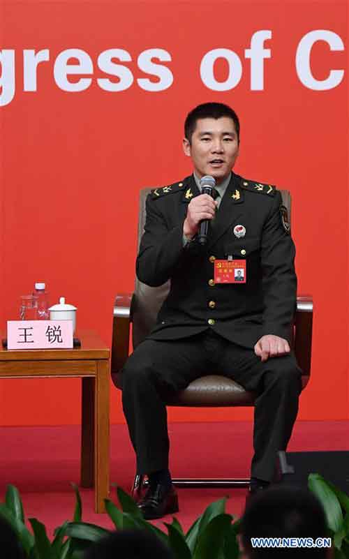 Wang Rui, a commander of an armored amphibious assault vehicle of a combined arms brigade in the 74th Army corps of the People's Liberation Army, answers questions during a group interview on "solid strides on the path of building a powerful military with Chinese characteristics", held by the press center of the 19th National Congress of the Communist Party of China (CPC) in Beijing, capital of China, Oct. 22, 2017. (Xinhua/Chen Yehua)